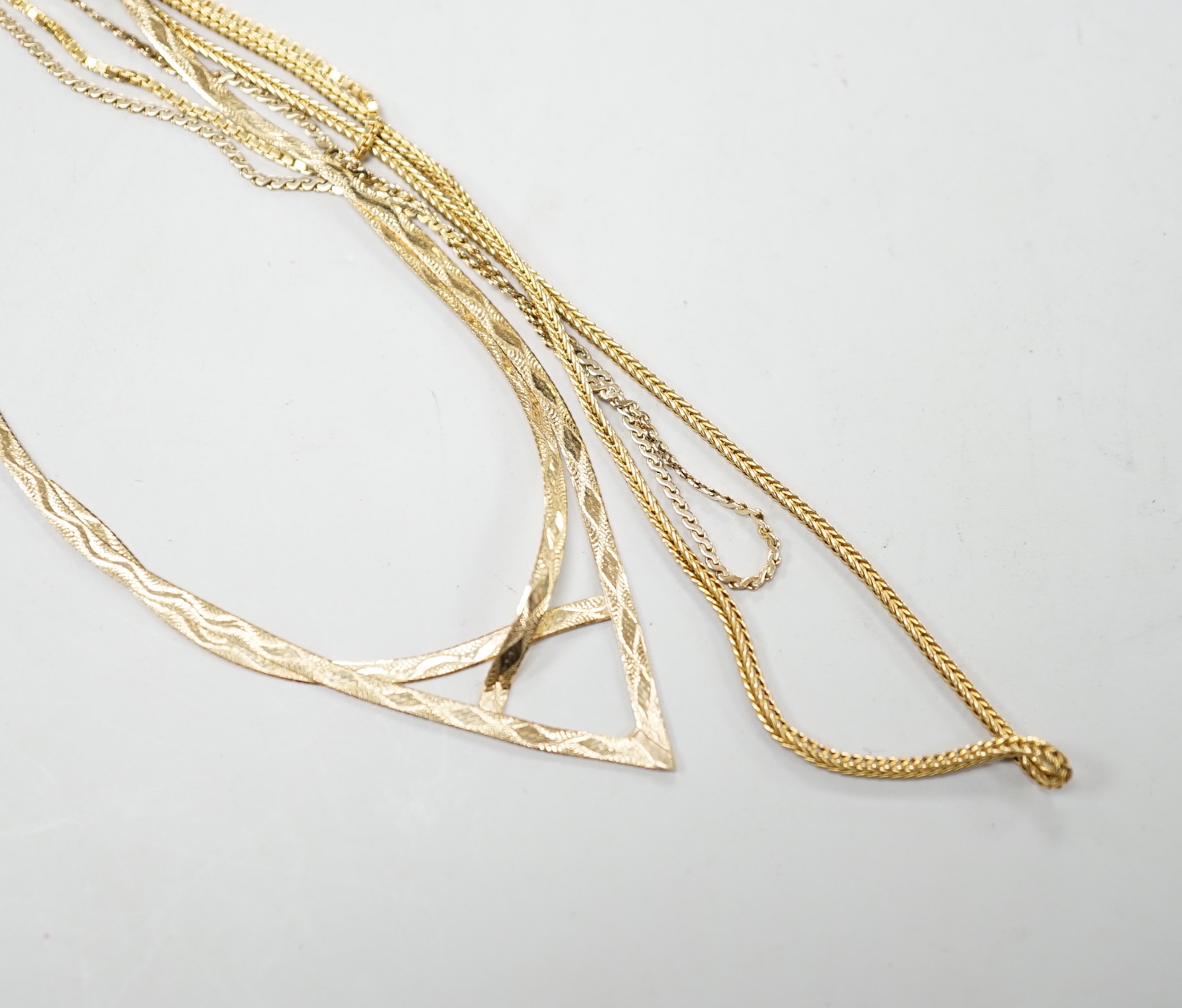 Two modern 9ct gold chains, longest 50cm, 6.3 grams, a 14k chain, 46cm, 2.6 grams and a 750 yellow metal chain, 38cm, 3.5 grams.